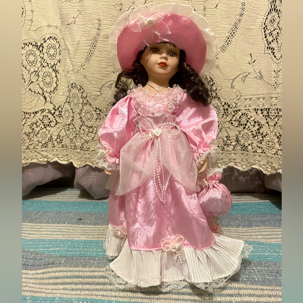 Vintage elegant porcelain doll in pink dress